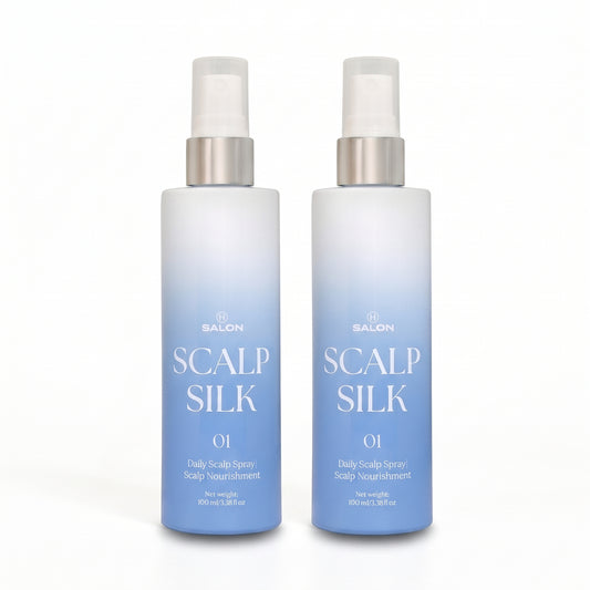 Two bottles of H Salon Scalp Silk 01 Daily Scalp Spray side by side on a white background. The bottles feature a white-to-light-blue gradient design with silver spray nozzles.