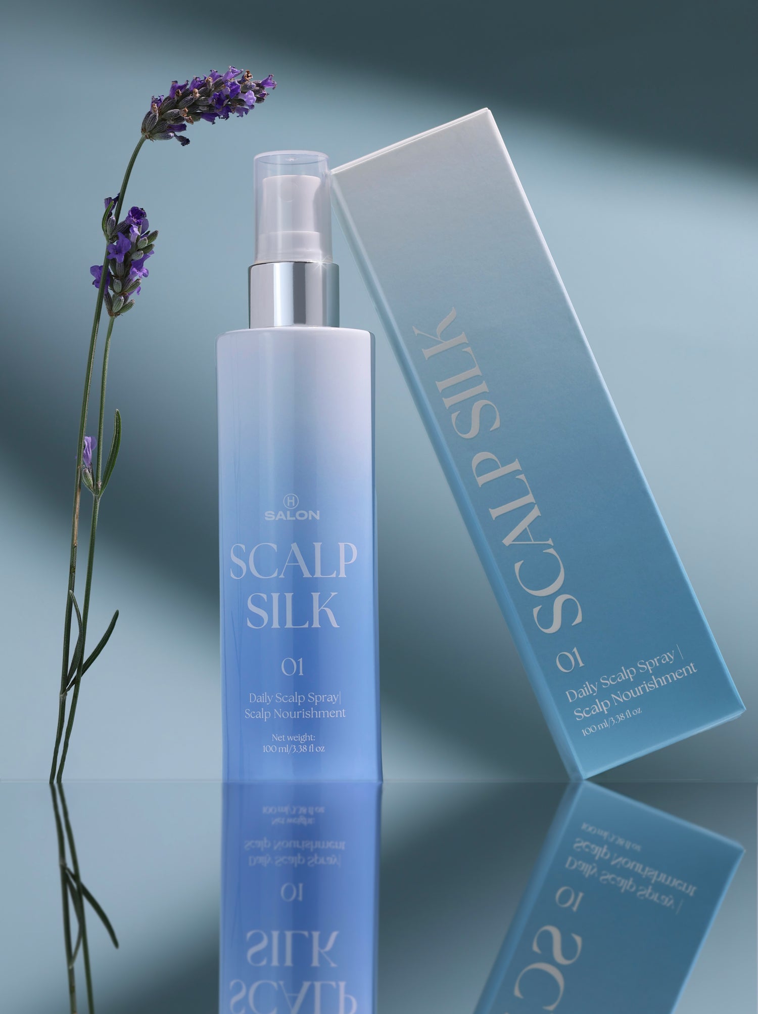 Scalp care product with bottle and box labeled 'Scalp Silk' on a reflective surface.